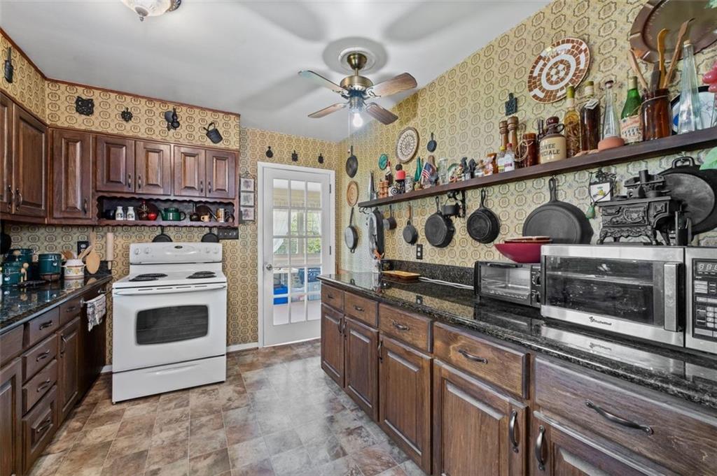2880 Sherwood Road Southeast Smyrna, GA 30082 - Photo 8 of 33 a kitchen with stainless steel appliances granite countertop a stove and cabinets
