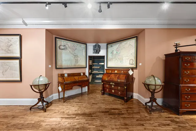 a living room with furniture a rug and a window