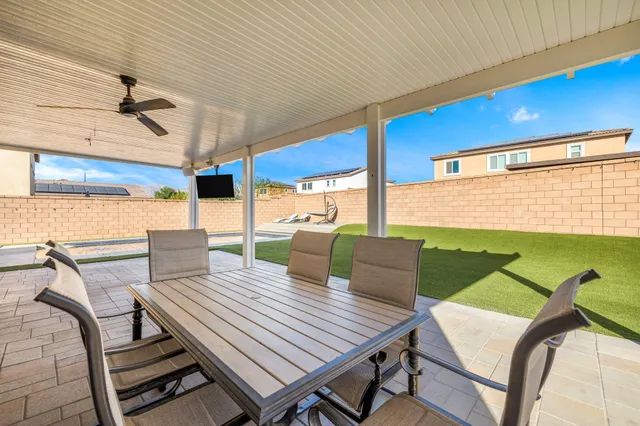 a view of a patio with a table and chairs