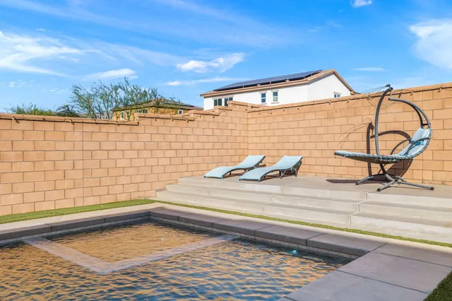 a view of a swimming pool with a patio