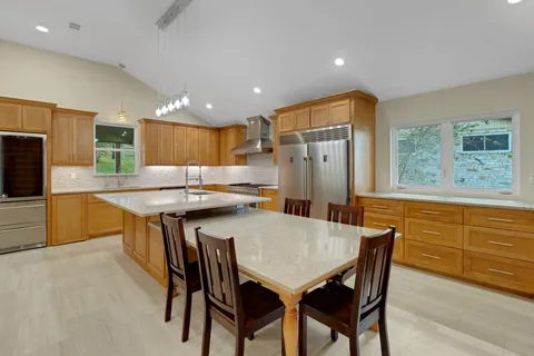 a kitchen with a stove and a table