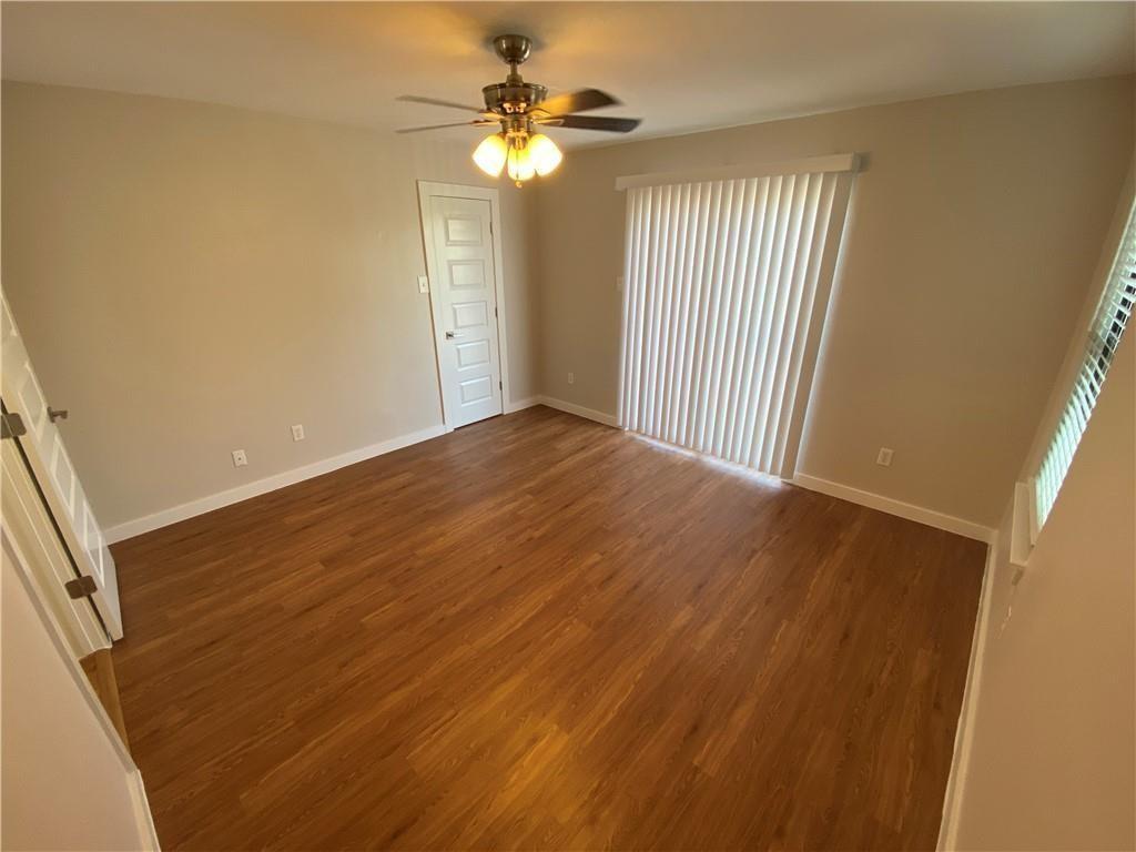 3506 Speedway, Unit 304 Austin, TX 78705 - Photo 3 of 7 wooden floor in an empty room with a window