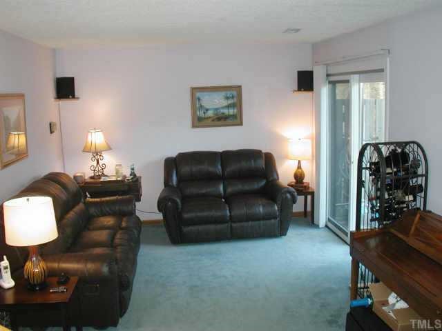 4319 Lake Ridge Drive, Unit 9B Raleigh, NC 27604 - Photo 3 of 10 a living room with furniture and a chair