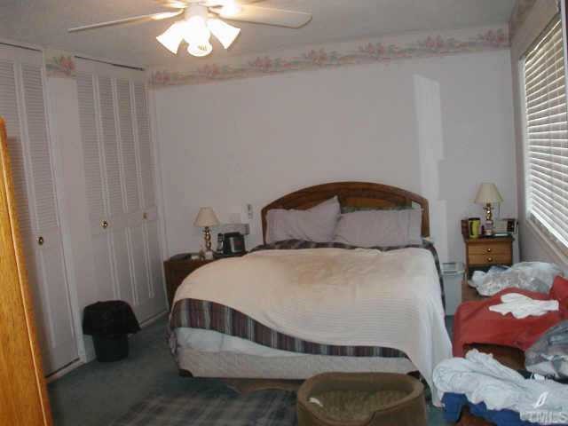 4319 Lake Ridge Drive, Unit 9B Raleigh, NC 27604 - Photo 6 of 10 a bedroom with a bed and a chair