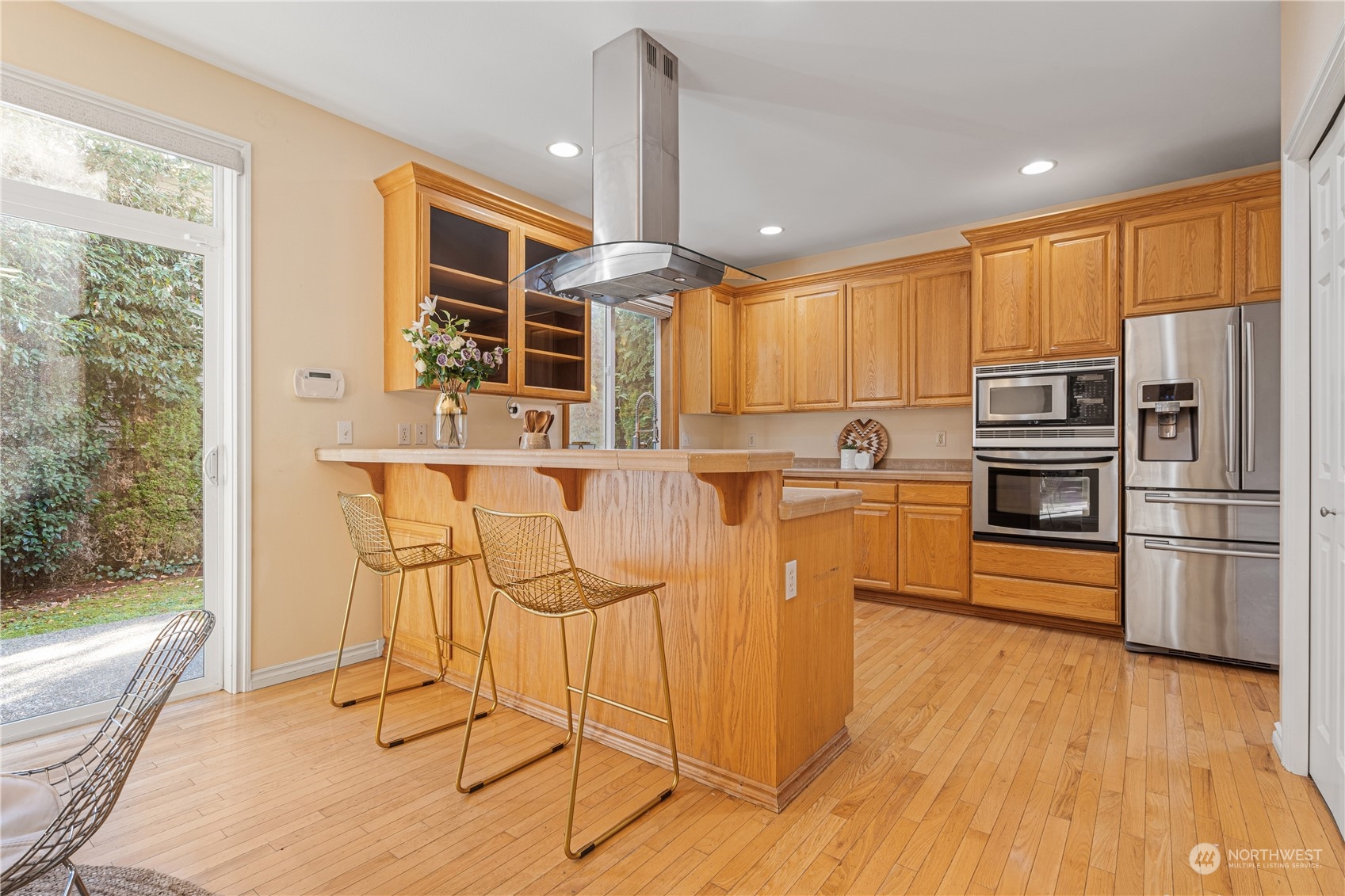 18529 33rd Avenue Southeast Bothell, WA 98012 - Photo 11 of 40 a kitchen with stainless steel appliances granite countertop a refrigerator a stove and a wooden floors