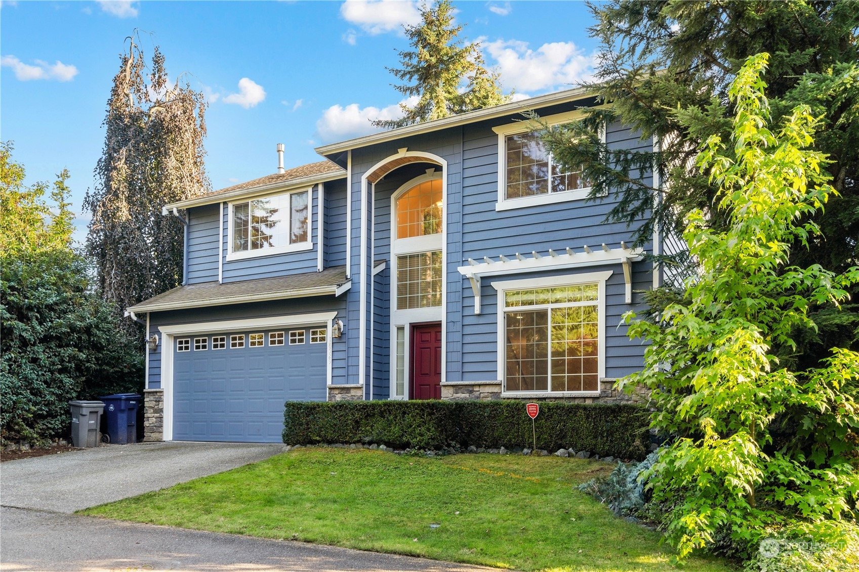 18529 33rd Avenue Southeast Bothell, WA 98012 - Photo 2 of 40 a front view of a house with a yard and garage