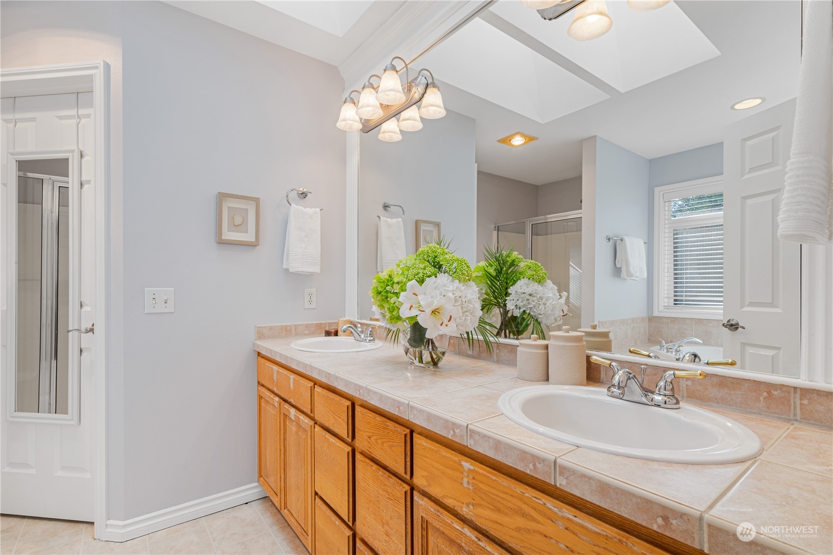18529 33rd Avenue Southeast Bothell, WA 98012 - Photo 25 of 40 a bathroom with a granite countertop sink a large mirror and a shower