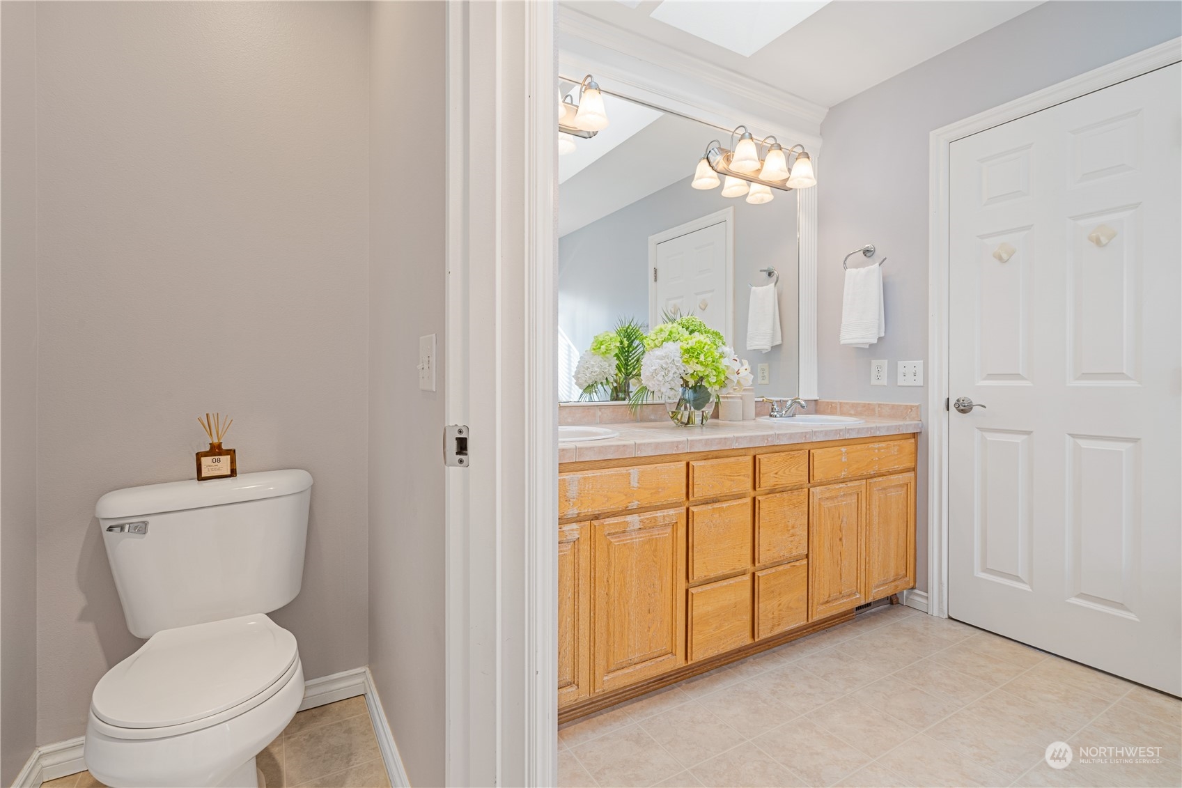 18529 33rd Avenue Southeast Bothell, WA 98012 - Photo 26 of 40 a spacious bathroom with a granite countertop toilet sink and mirror