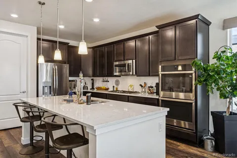 a stove top oven sitting inside of a kitchen