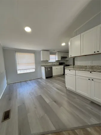 a large kitchen with a lot of cabinets and appliances