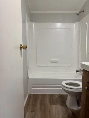 a bathroom with a toilet and a shower