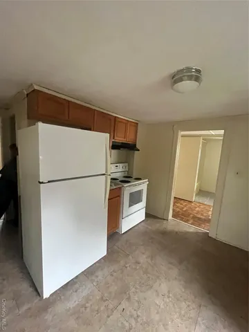 a kitchen with stainless steel appliances a refrigerator and a stove top oven