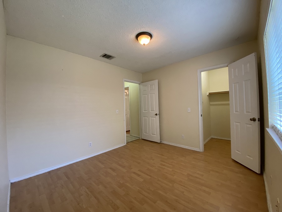 1903 Balsam Way Round Rock, TX 78665 - Photo 16 of 21 A well-lit bedroom #2 with laminate flooring and ample closet space awaits customization.