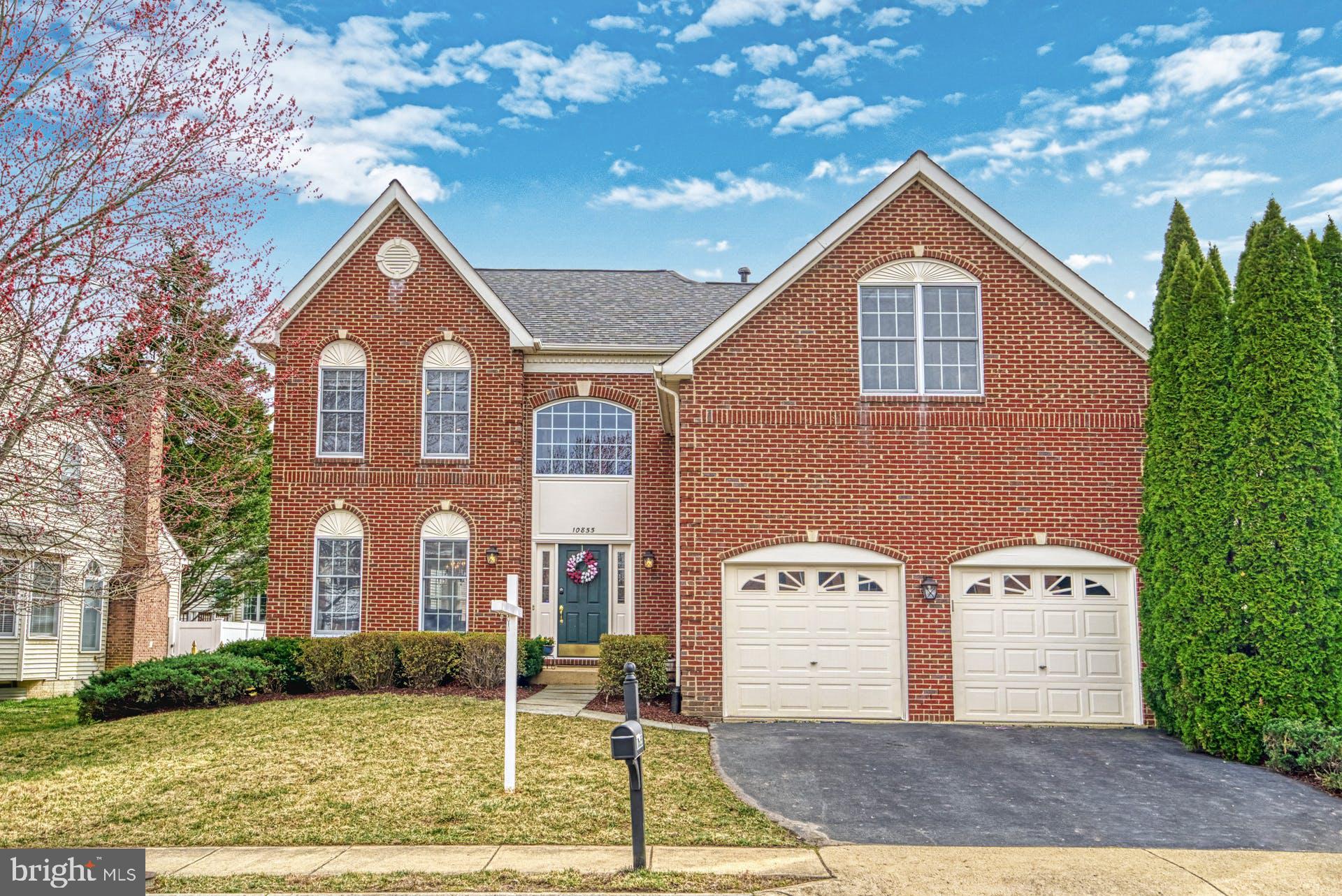 10855 Hunter Gate Way Reston, VA 20194 - Photo 2 of 57 a front view of a house with a yard
