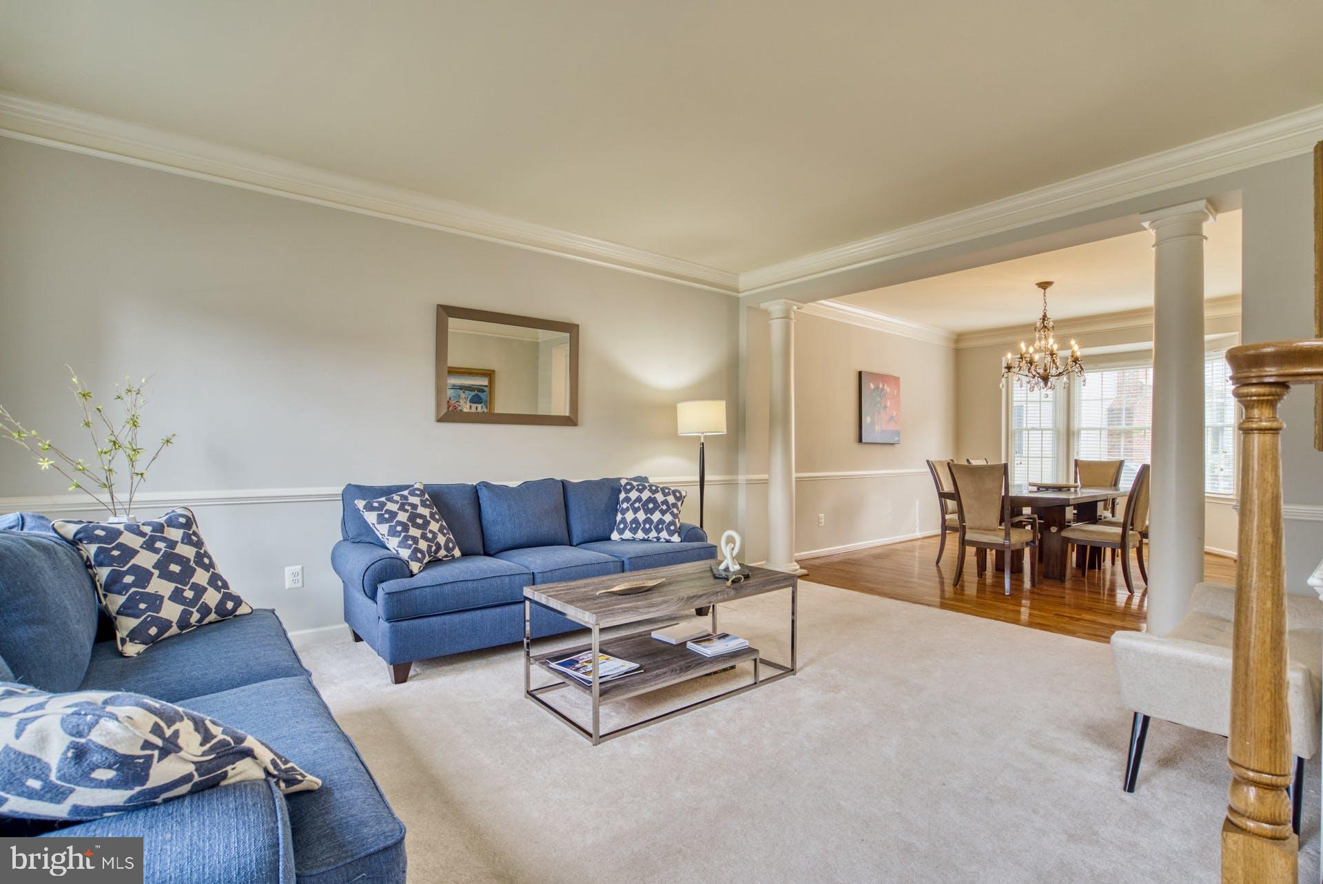 10855 Hunter Gate Way Reston, VA 20194 - Photo 12 of 57 a living room with furniture and a large window with garden view