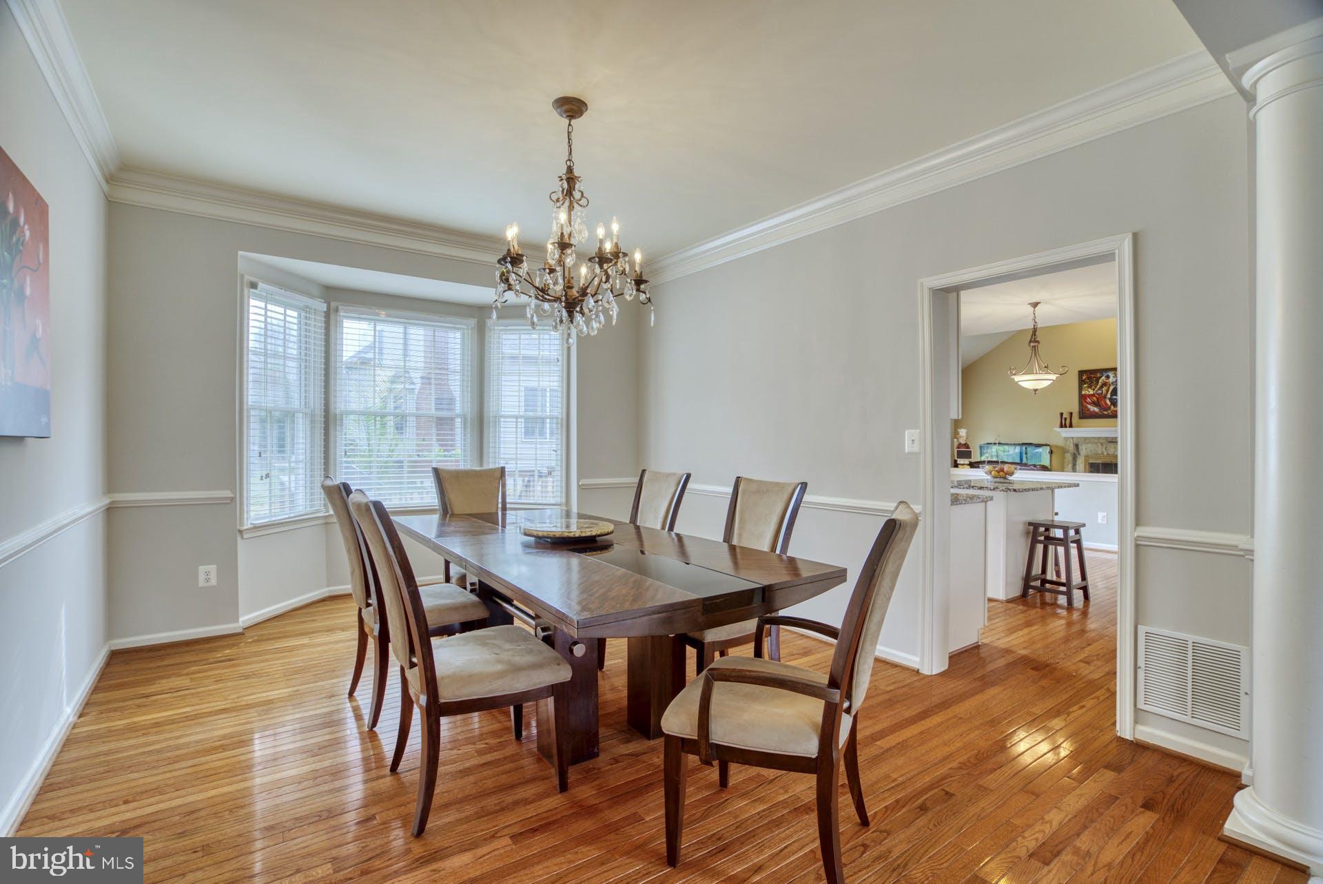 10855 Hunter Gate Way Reston, VA 20194 - Photo 14 of 57 a view of a dining room with furniture and wooden floor