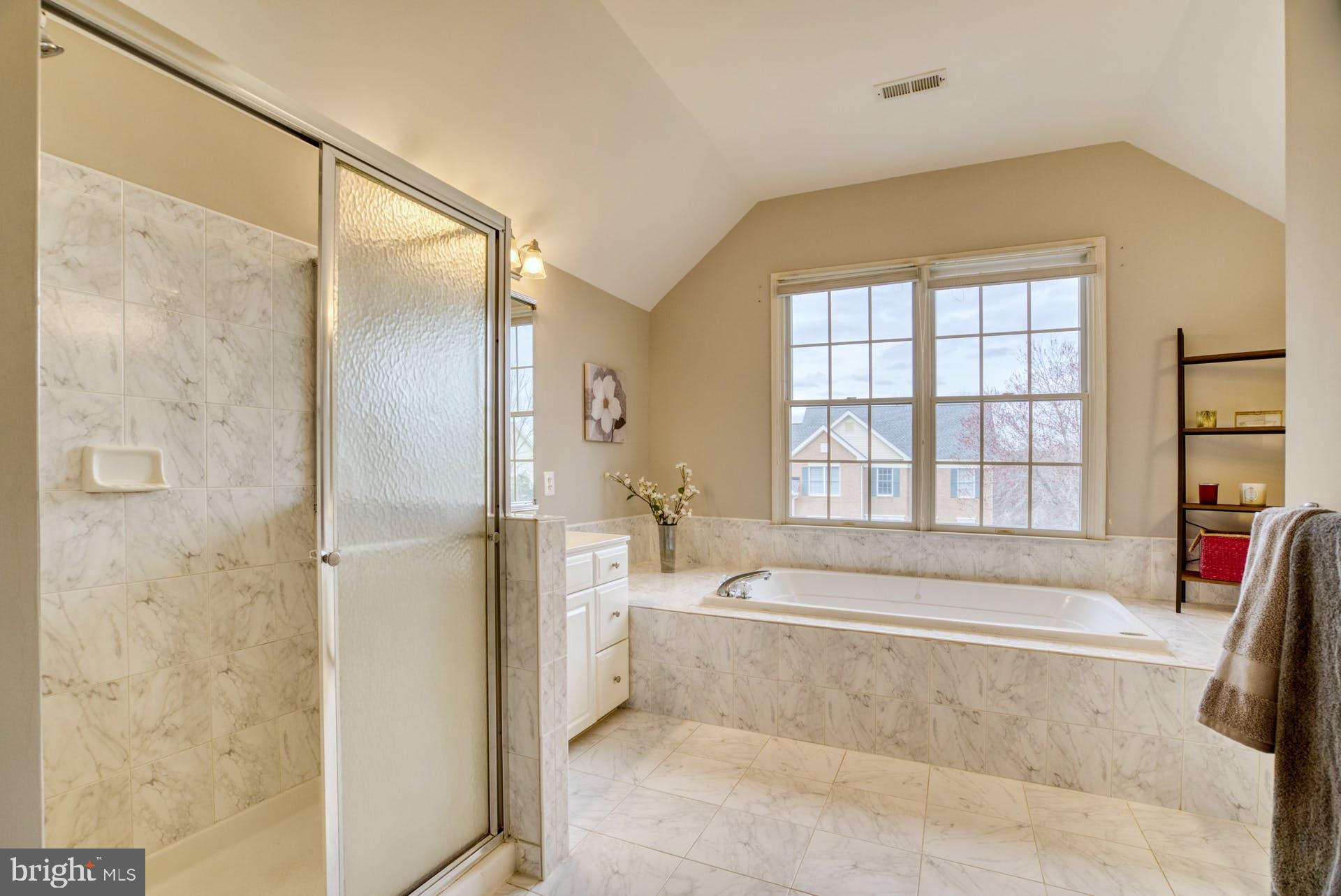 10855 Hunter Gate Way Reston, VA 20194 - Photo 23 of 57 a spacious bathroom with a tub shower and sink