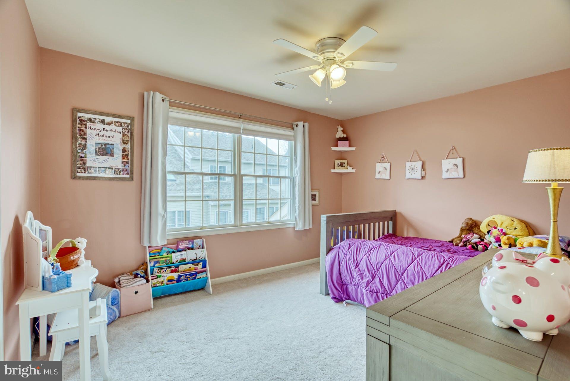 10855 Hunter Gate Way Reston, VA 20194 - Photo 28 of 57 a bedroom with a bed and a chandelier