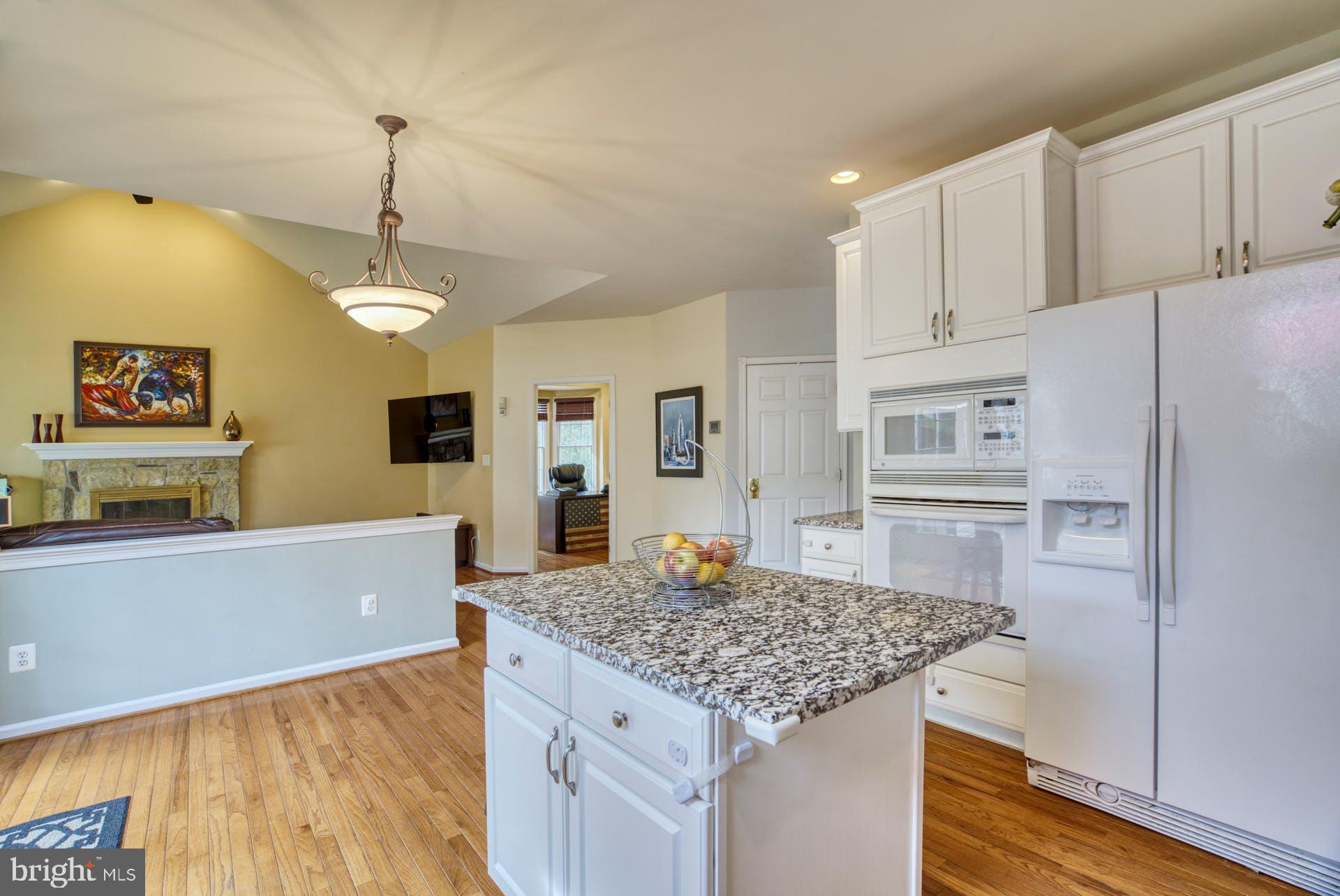 10855 Hunter Gate Way Reston, VA 20194 - Photo 10 of 57 a kitchen with kitchen island a counter top space a sink stainless steel appliances and cabinets