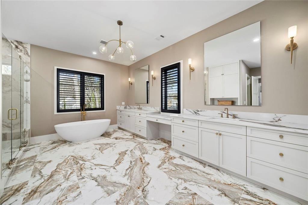 2309 Dinsmore Road Milton, GA 30004 - Photo 27 of 87 a spacious bedroom with a large bed and a chandelier