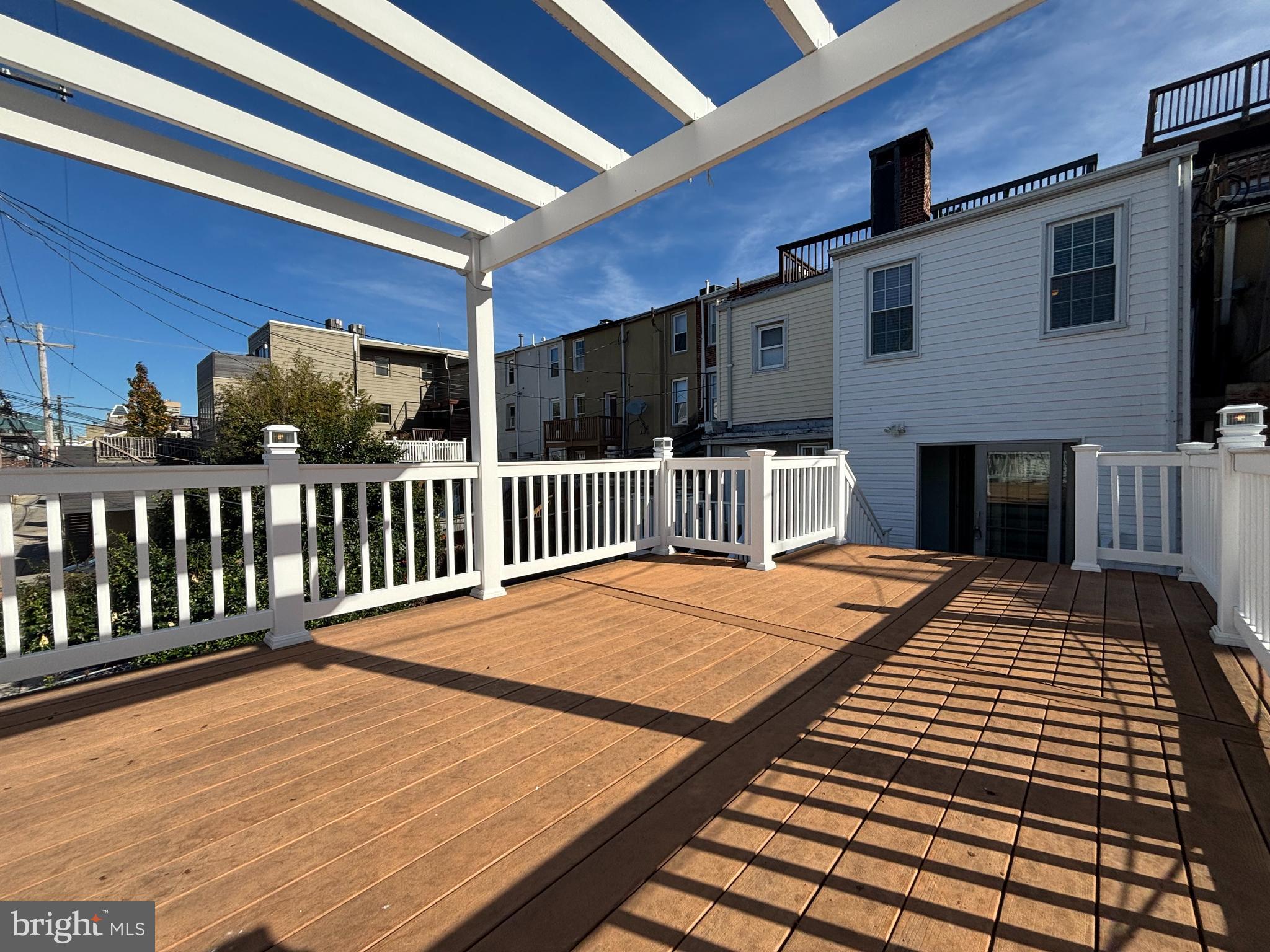 1218 Riverside Avenue Baltimore, MD 21230 - Photo 14 of 38 a view of a balcony with wooden floor and fence
