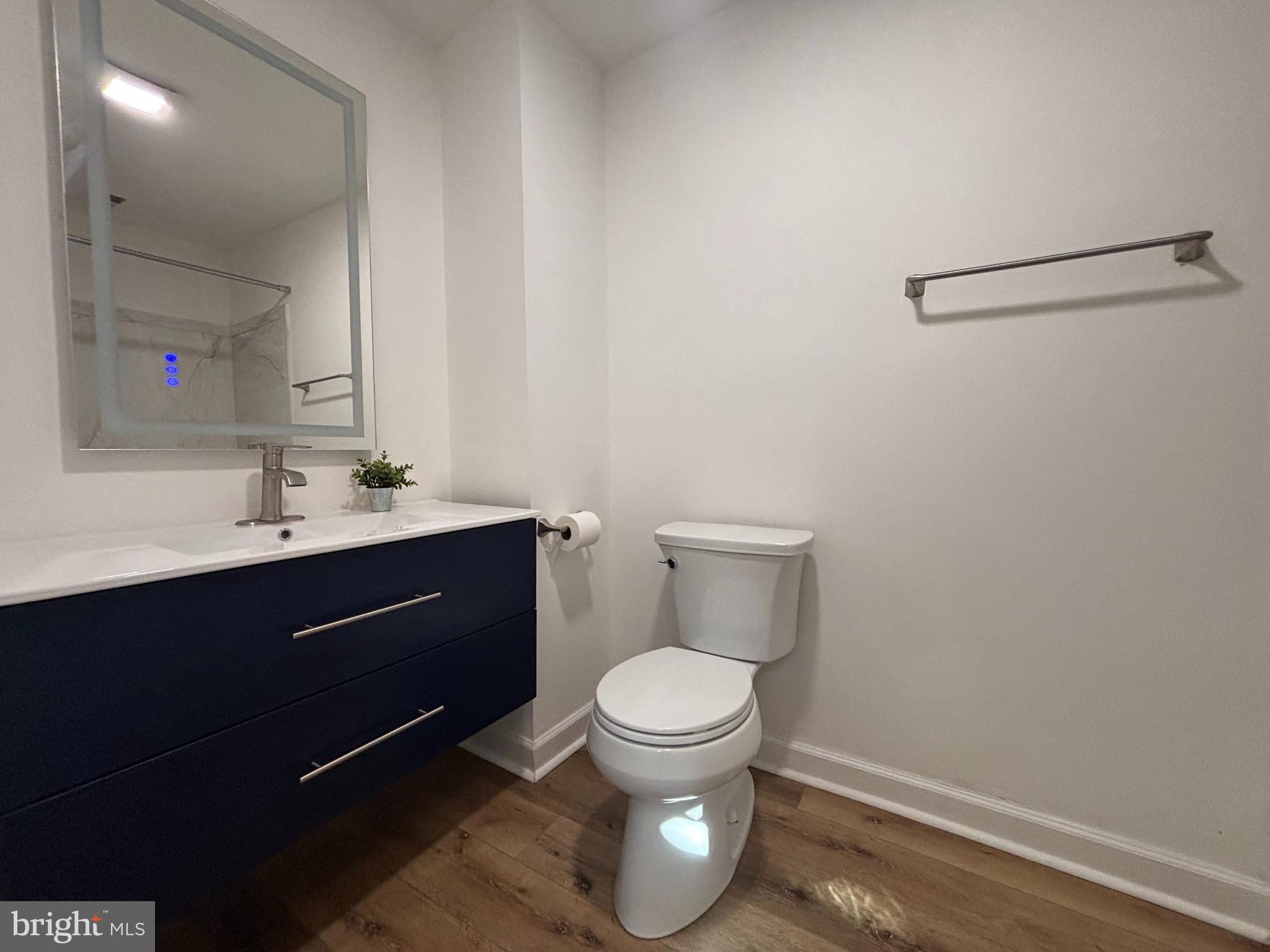 1218 Riverside Avenue Baltimore, MD 21230 - Photo 18 of 38 a bathroom with a toilet sink vanity and mirror