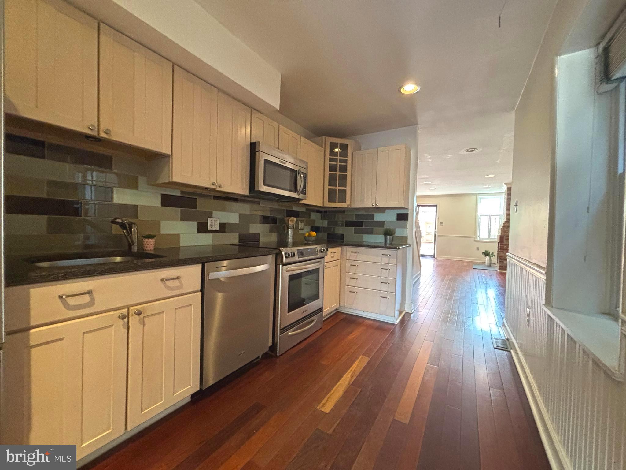 1218 Riverside Avenue Baltimore, MD 21230 - Photo 8 of 38 a kitchen with cabinets stainless steel appliances a sink and a stove