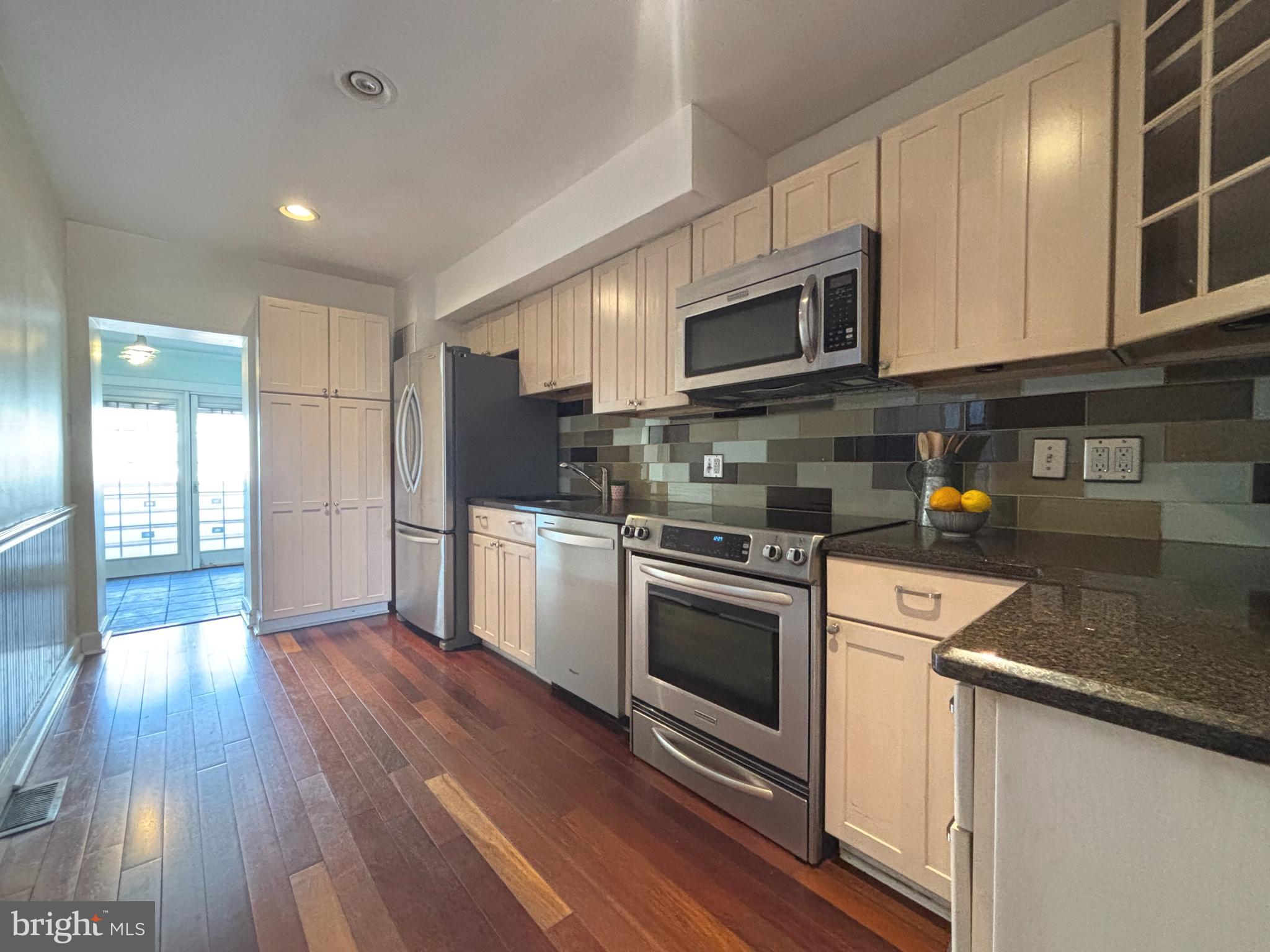 1218 Riverside Avenue Baltimore, MD 21230 - Photo 9 of 38 a kitchen with stainless steel appliances granite countertop a stove a sink and a microwave