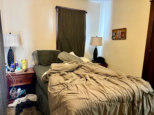 a bedroom with a bed and a lamp