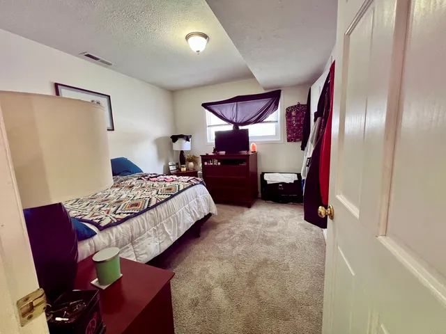 a bed room with a bed and a chair