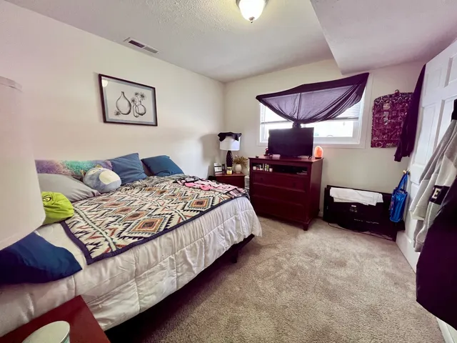 a bedroom with a bed and a window