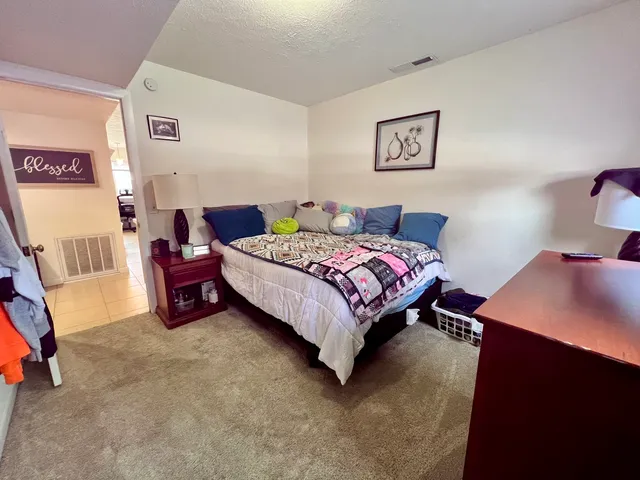 a bedroom with a bed and a dresser