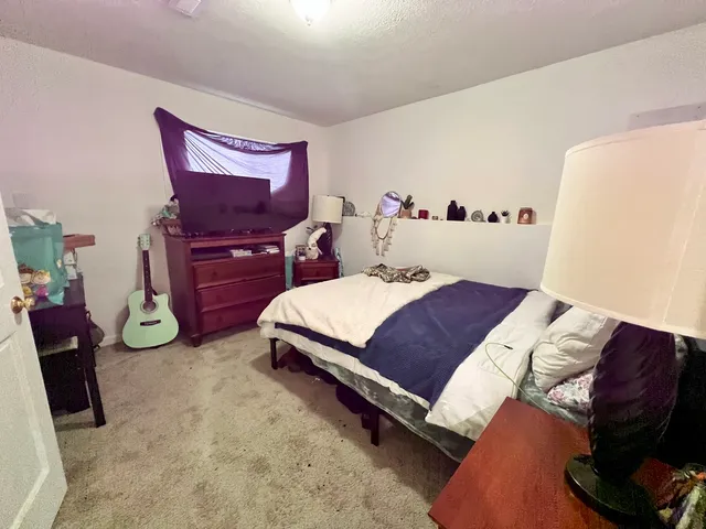 a bedroom with a bed and a mirror