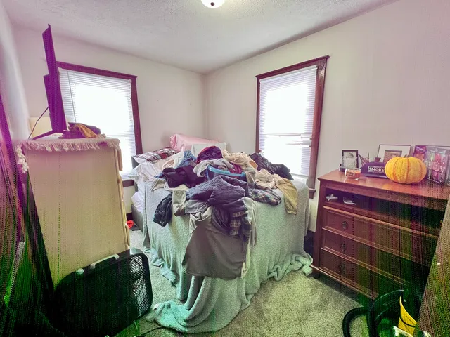 a bed room with a bed and a window