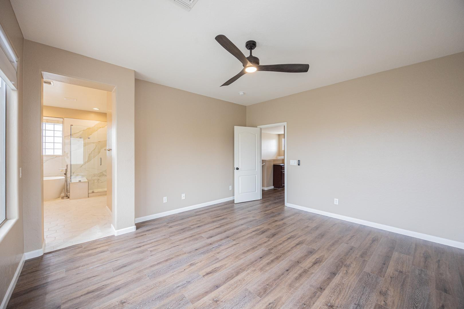 6539 West Jomax Road Phoenix, AZ 85083 - Photo 17 of 39 an empty room with wooden floor and windows