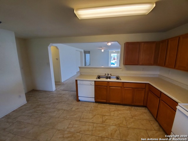 25714 Gold Yarrow San Antonio, TX 78260 - Photo 7 of 15 a kitchen with stainless steel appliances granite countertop a sink and cabinets