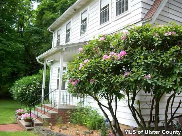 510 Pine Bush Road Stone Ridge, NY 12484 - Photo 2 of 16 a flower plants in front of a house