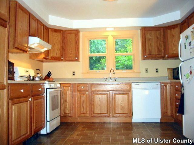 510 Pine Bush Road Stone Ridge, NY 12484 - Photo 3 of 16 a kitchen with stainless steel appliances granite countertop a stove a sink and a microwave