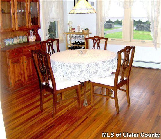 510 Pine Bush Road Stone Ridge, NY 12484 - Photo 4 of 16 a dining room with furniture a rug and wooden floor