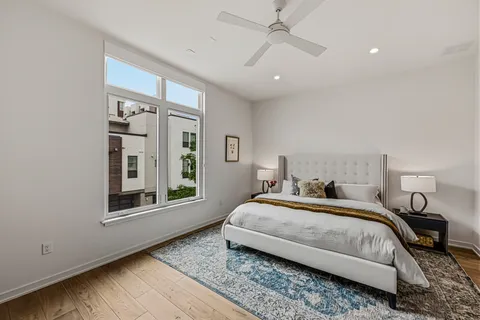 a bedroom with a large bed and a window