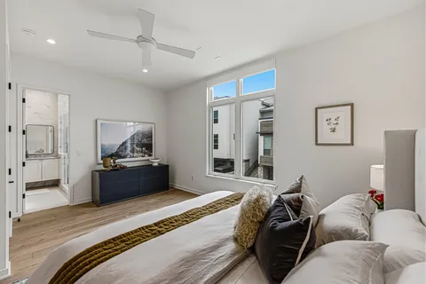 a bedroom with a bed and wooden floor