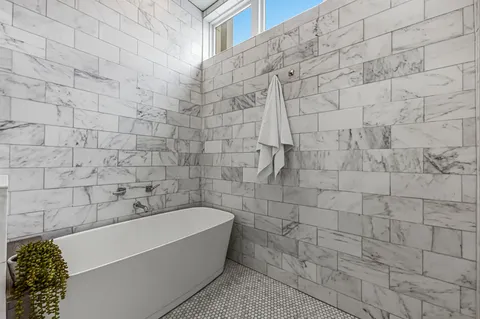 a bathroom with a bathtub and shower