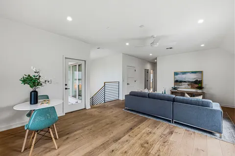 a living room with furniture a couch and a potted plant