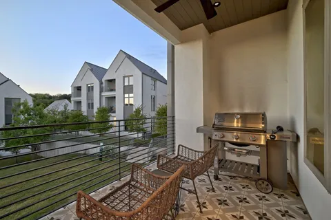 a view of a chairs and a table in the balcony