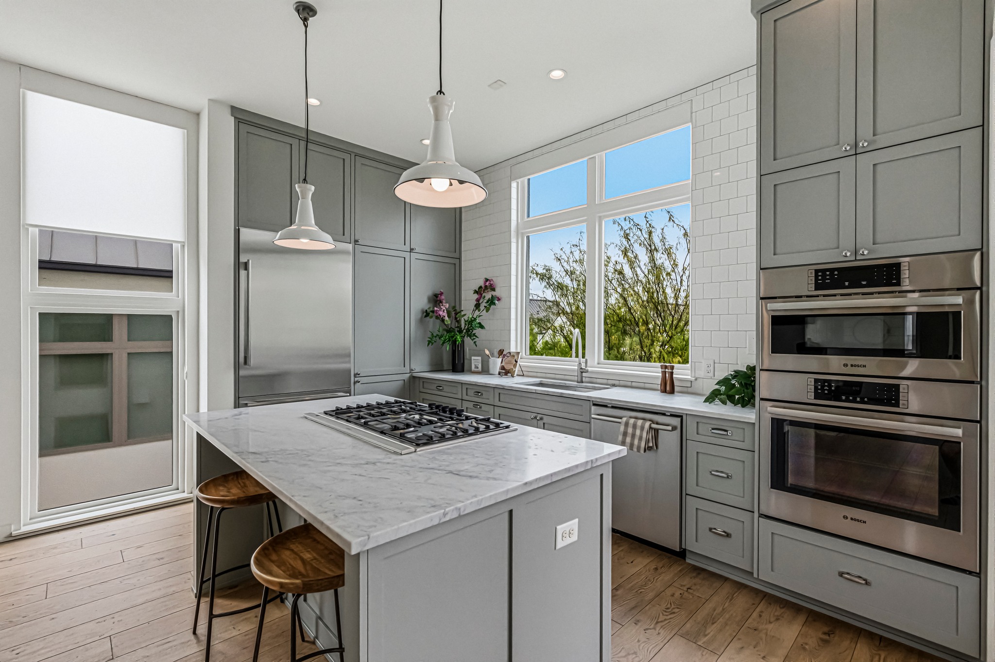 2512 Watkins Way Austin, TX 78746 - Photo 5 of 40 Quartz countertops and sleek expansive cabinetry throughout