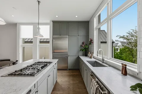 a kitchen with a sink stove and refrigerator