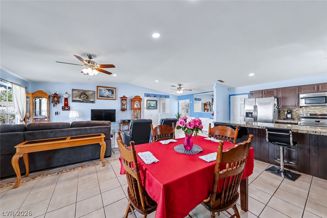 3107 Trueno Road Henderson, NV 89014 - Photo 37 of 37 An open floorplan seamlessly connects the living and dining areas to a kitchen with granite counters.