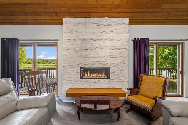 a living room with furniture fireplace and flat screen tv