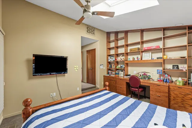 a living room with furniture a flat screen tv and a large window