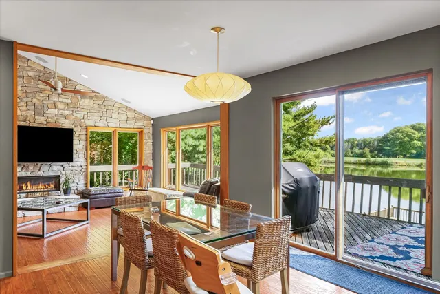 a kitchen with stainless steel appliances a kitchen island a cabinets wooden floor and a sink